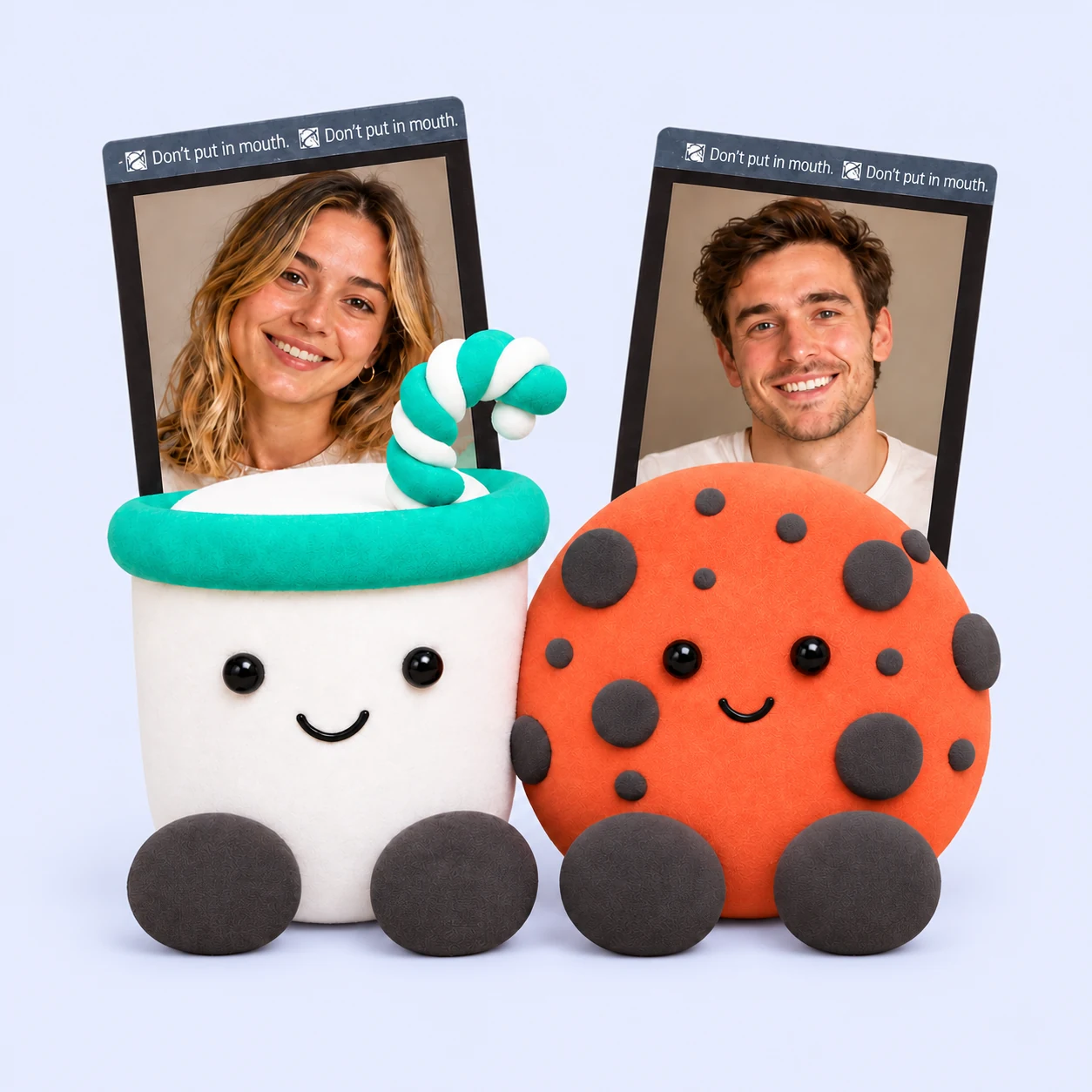 Two people with their finished teal and orange foam clay characters.